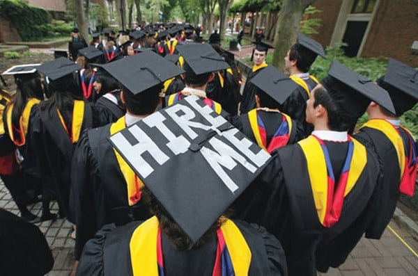 A new grad with a 'Hire me' graduation cap