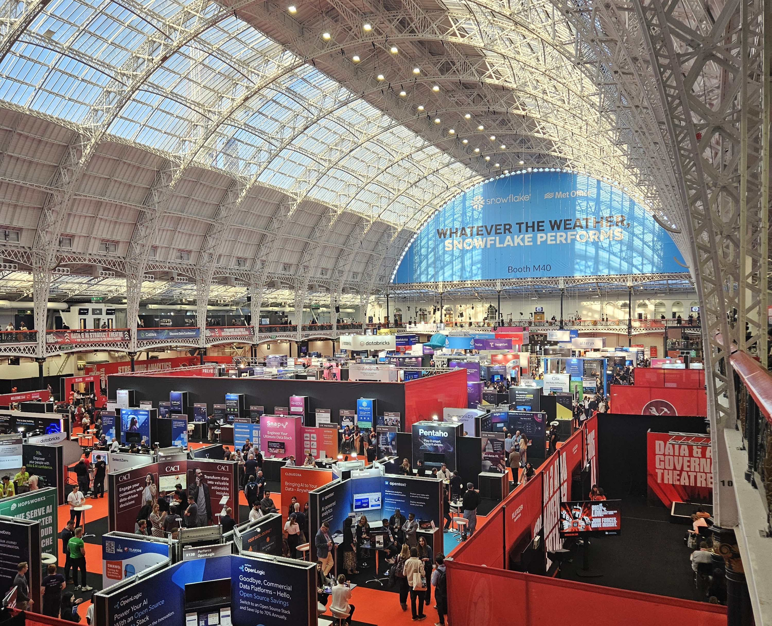 A busy conference hall with many attendees networking.