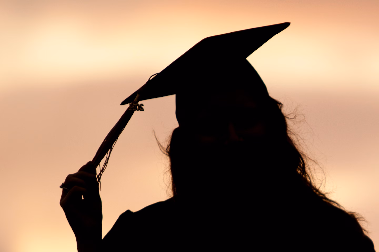 A graduate standing looking out..